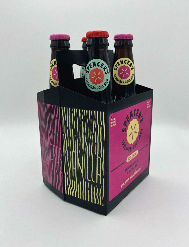 Photo of a four pack of root beer bottles (Assorted flavored) in a carrying box.